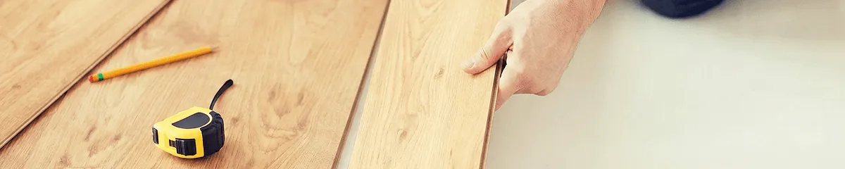 A professional installing wood flooring in Chicago, IL