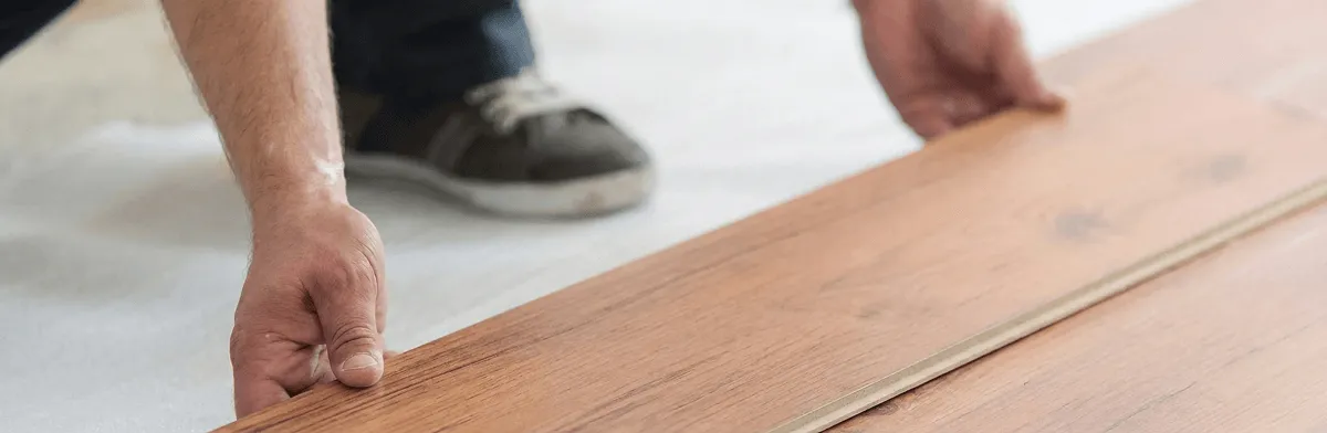 A professional installing laminate flooring in Chicago, IL